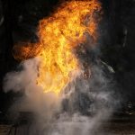 FireGuy creating a fireball on a stage for a show.