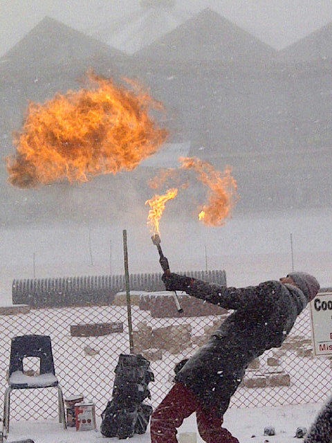 FireGuy blowing a fireball on a snowy day.