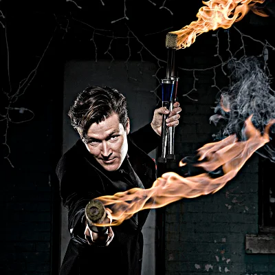 FireGuy looks to be choosing you while holding 3 of his juggling fire sticks.
