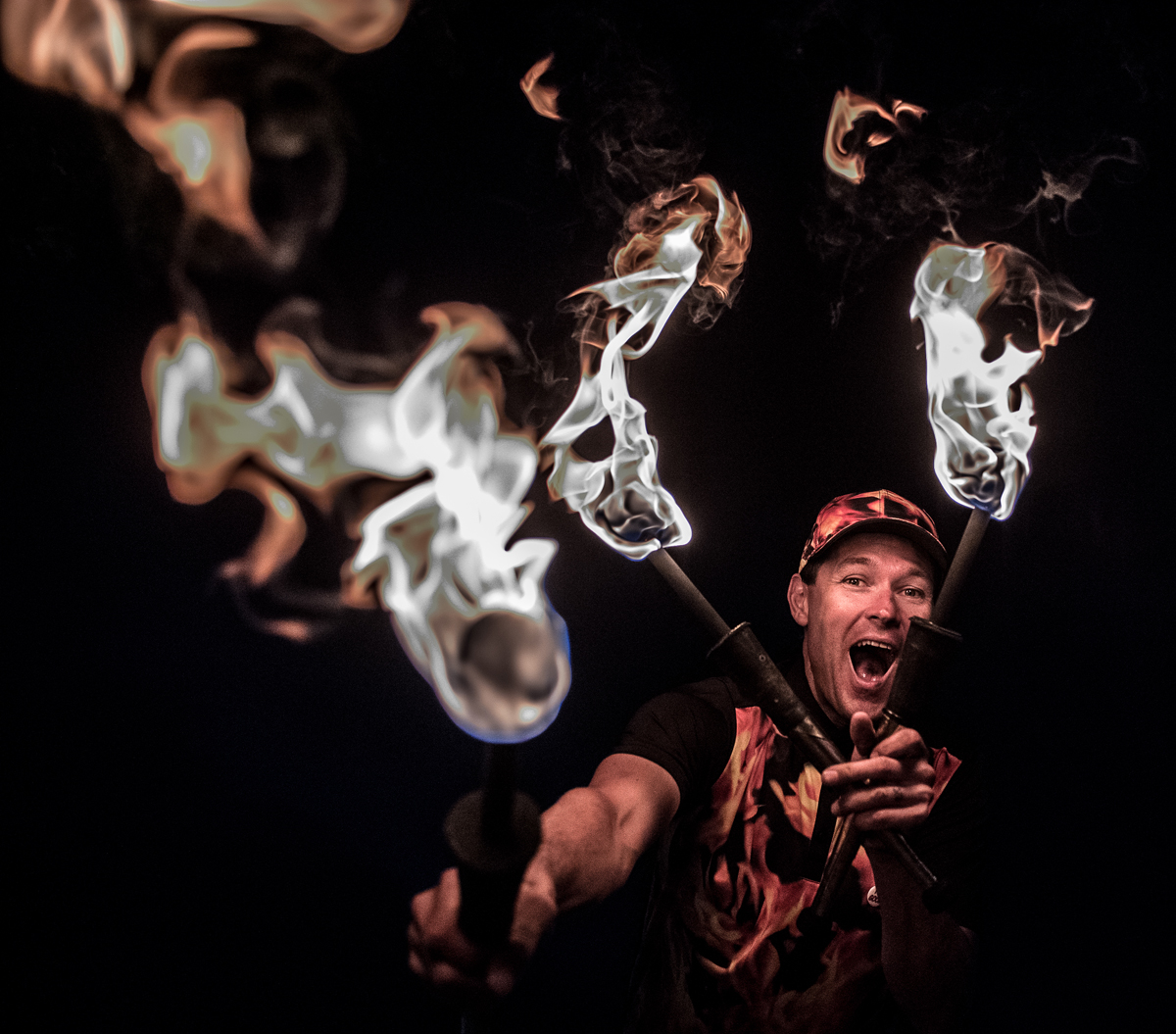 FireGuy holding out fire sticks and pointing in front of him.
