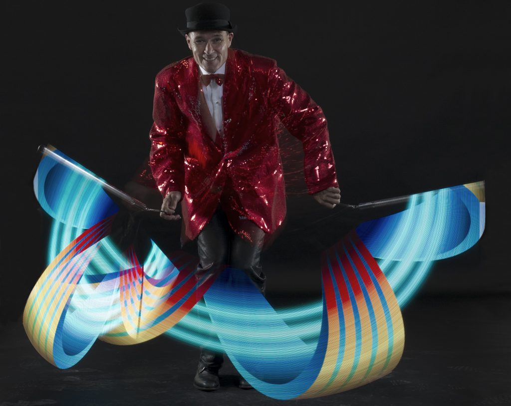 FireGuy showing off some LED spinners while dressed up in red sequin suit and a bow tie!