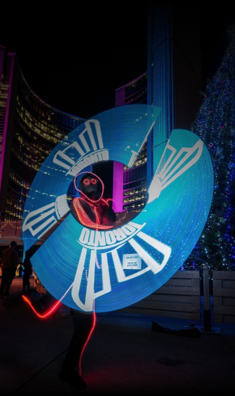GlowGuy dancing with an LED spinner creating an imact saying 'Toronto' on it while performing in Toronto itself.